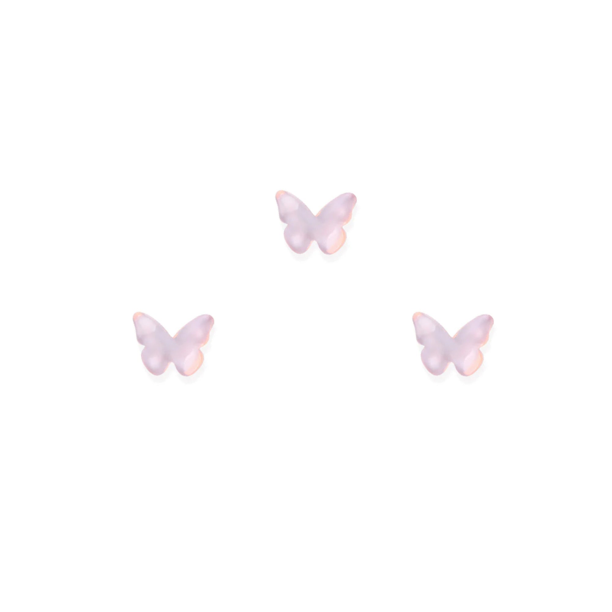 Three pink butterfly-shaped nail charms on a white background
