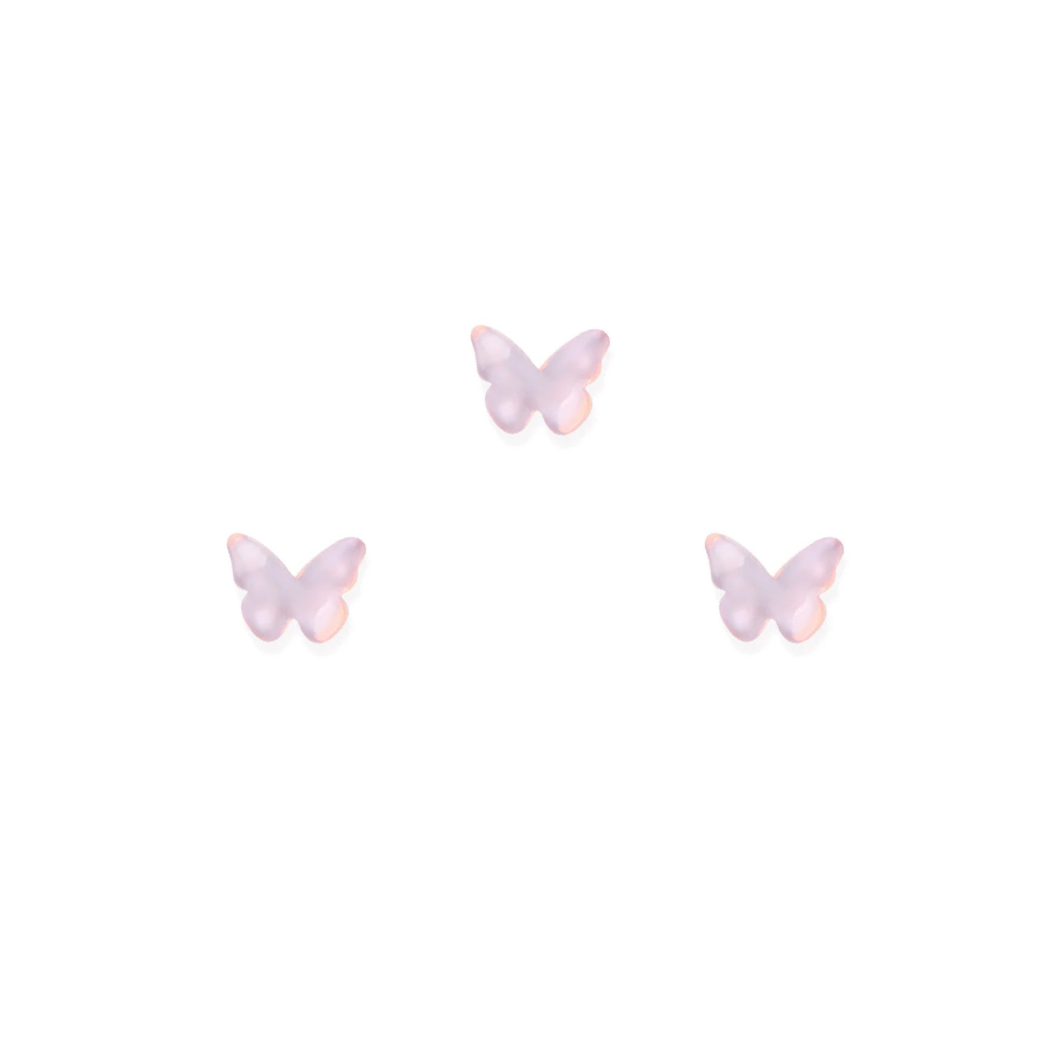 Three pink butterfly-shaped nail charms on a white background