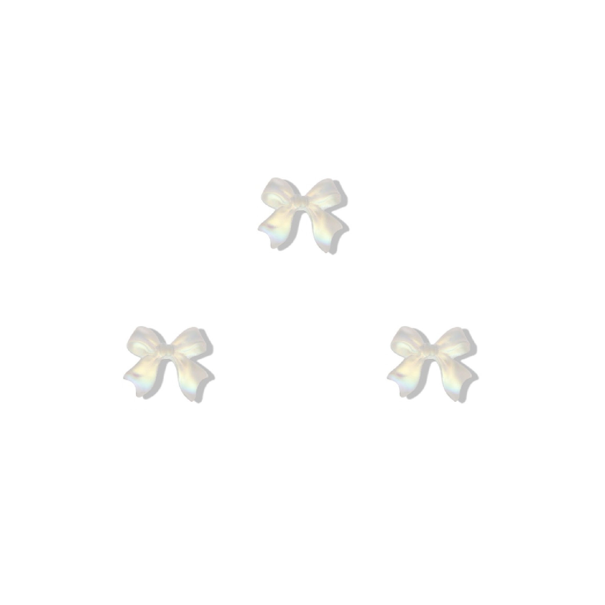 Set of three white bow-shaped nail charms on a white background